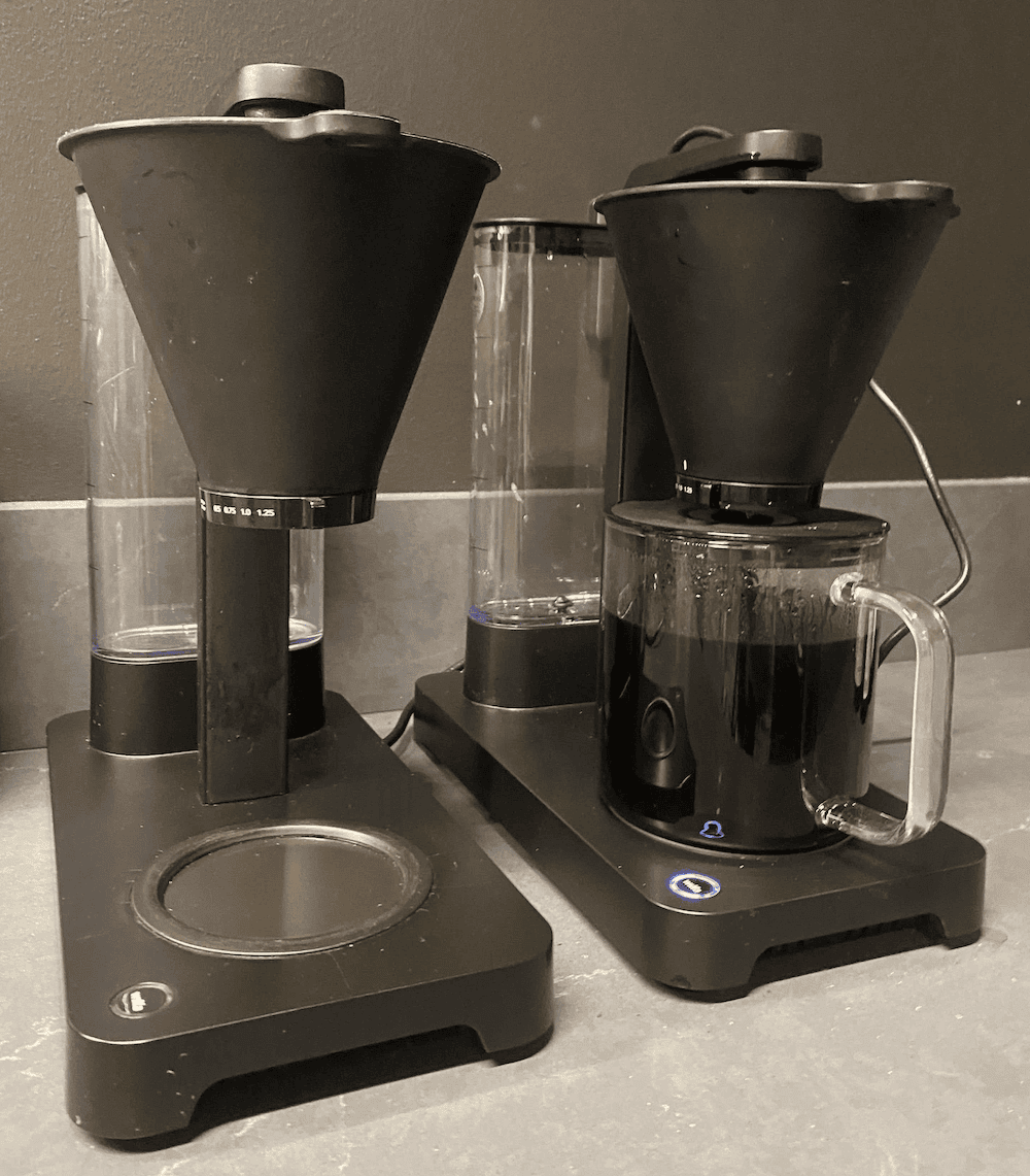 Two coffee machines, one missing a glass jug